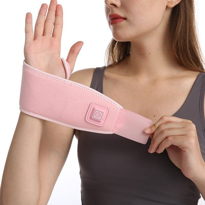 Heated wrist brace worn on hand showing thumb opening and wrap fit