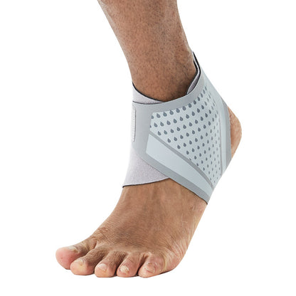Gray adjustable ankle support wrap sleeve worn on foot