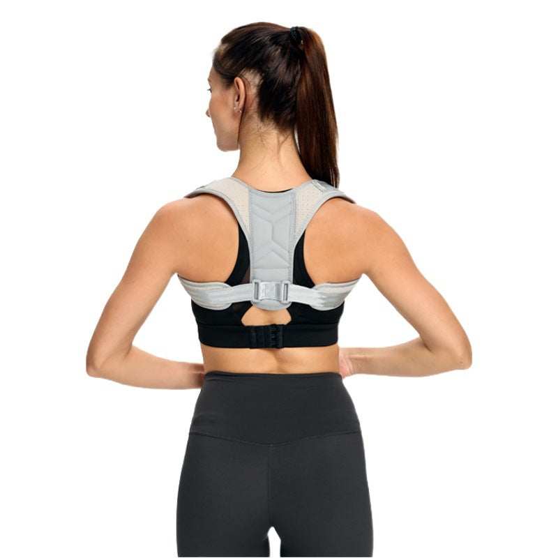 Adult model wearing adjustable back posture corrector brace showing upper back panel and shoulder straps