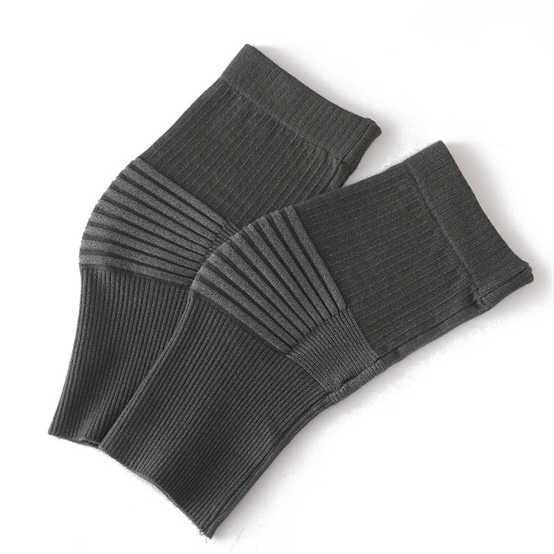 Light blue knee support sleeves worn on legs showing flexible knit fit