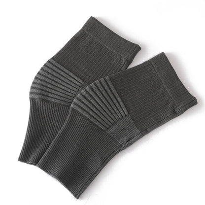 Light blue knee support sleeves worn on legs showing flexible knit fit