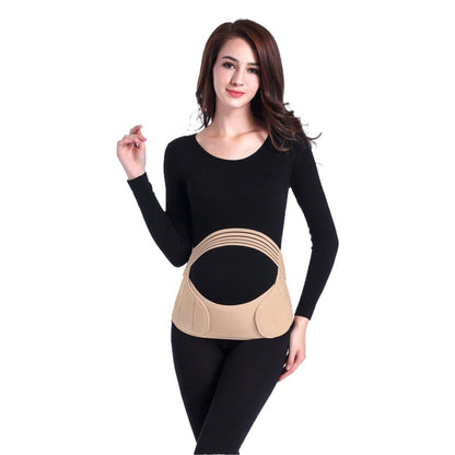 Model wearing a beige adjustable maternity belly support belt over black clothing