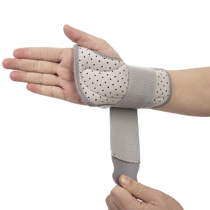 Gray thumb wrist brace being adjusted to show secure wrap fit and thumb coverage