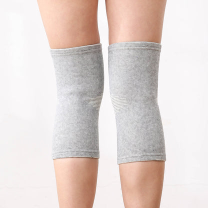 Gray pair of knitted knee support sleeves worn on both knees front view