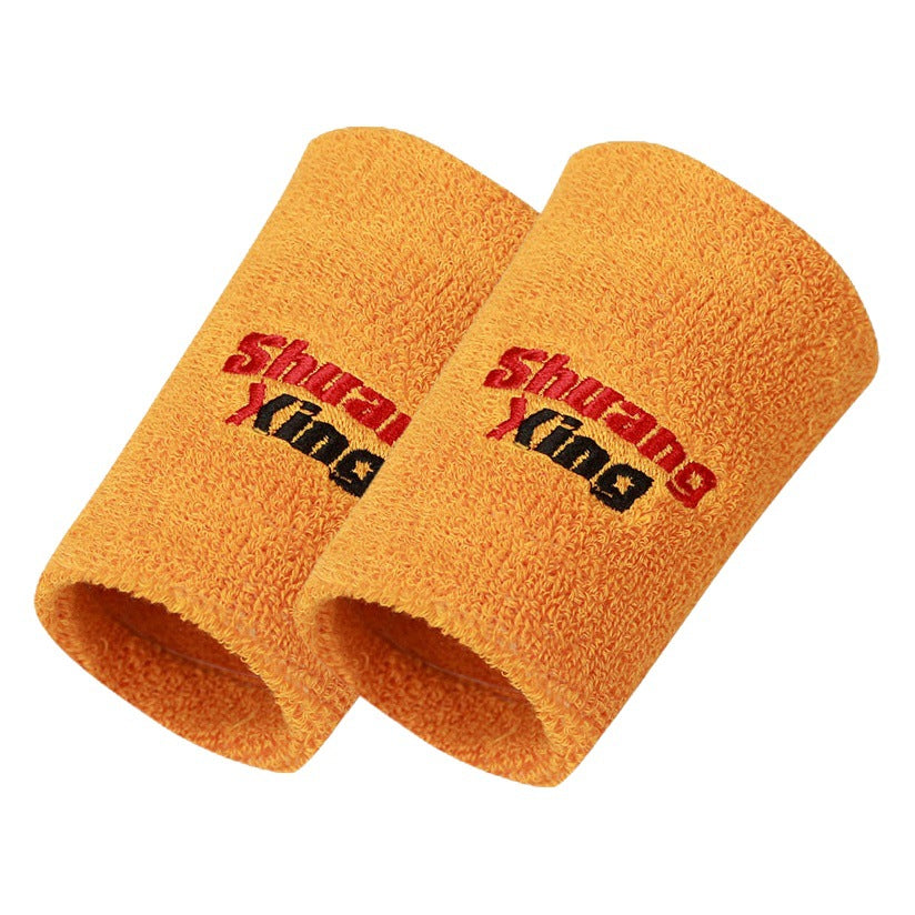 Orange cotton terry wrist sweatband on a white background