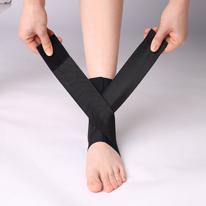 Black adjustable ankle brace worn on foot with heel opening and wrap straps