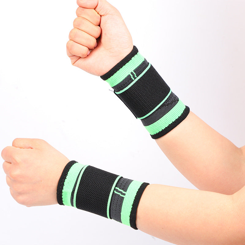 Green and black wrist support brace shown fitted on both wrists