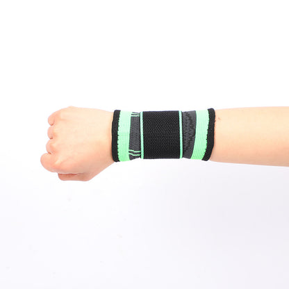 Adjustable wrist brace with thumb loop in green and black worn on wrist