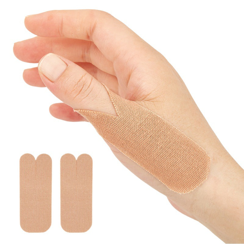 Multiple beige adhesive thumb support patches arranged in rows on white background