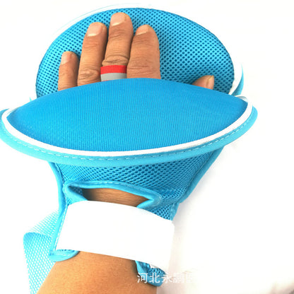 Adjustable mesh hand support glove worn on hand and wrist showing strap placement