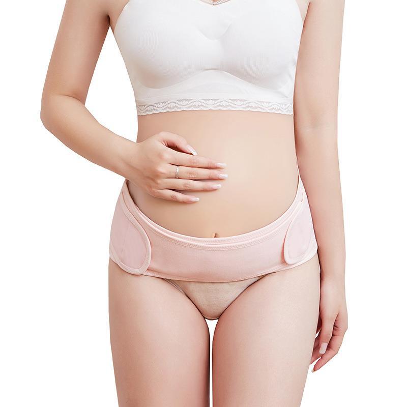 Pink maternity support belt showing adjustable side panels and front fit