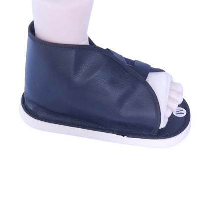 Black foot recovery shoe cover worn on foot showing side profile and coverage