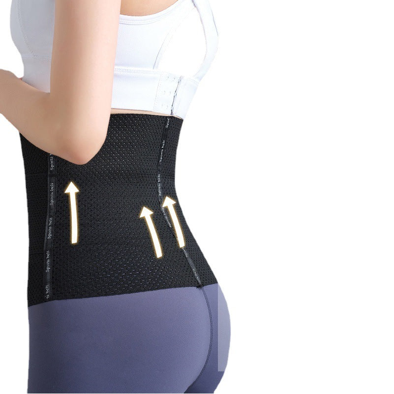 Black postpartum belly support belt worn on model, showing wraparound abdominal and waist support.