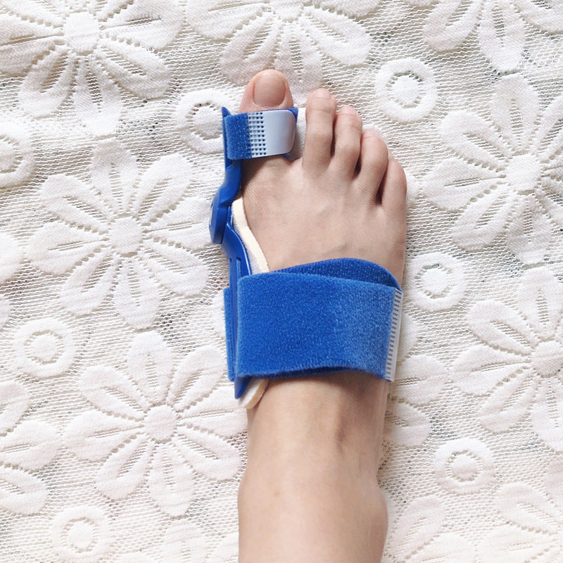 Blue bunion corrector toe brace worn on foot showing big toe and forefoot fit