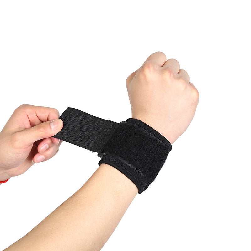 Black thumb wrist brace with adjustable strap being tightened for a secure fit