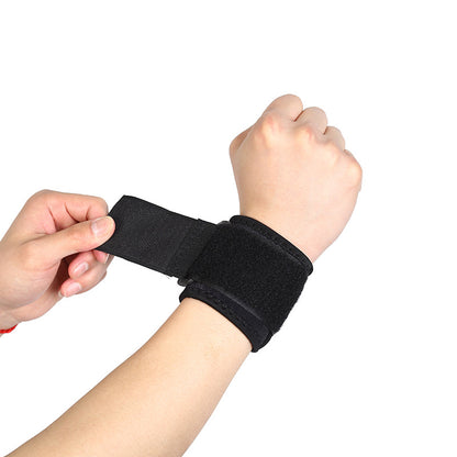 Black thumb wrist brace with adjustable strap being tightened for a secure fit