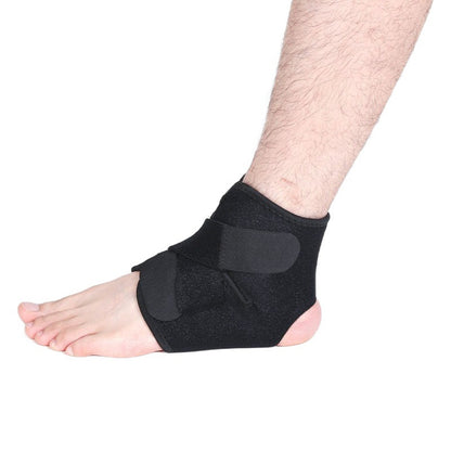 Black adjustable compression ankle brace with wrap straps worn on foot side view